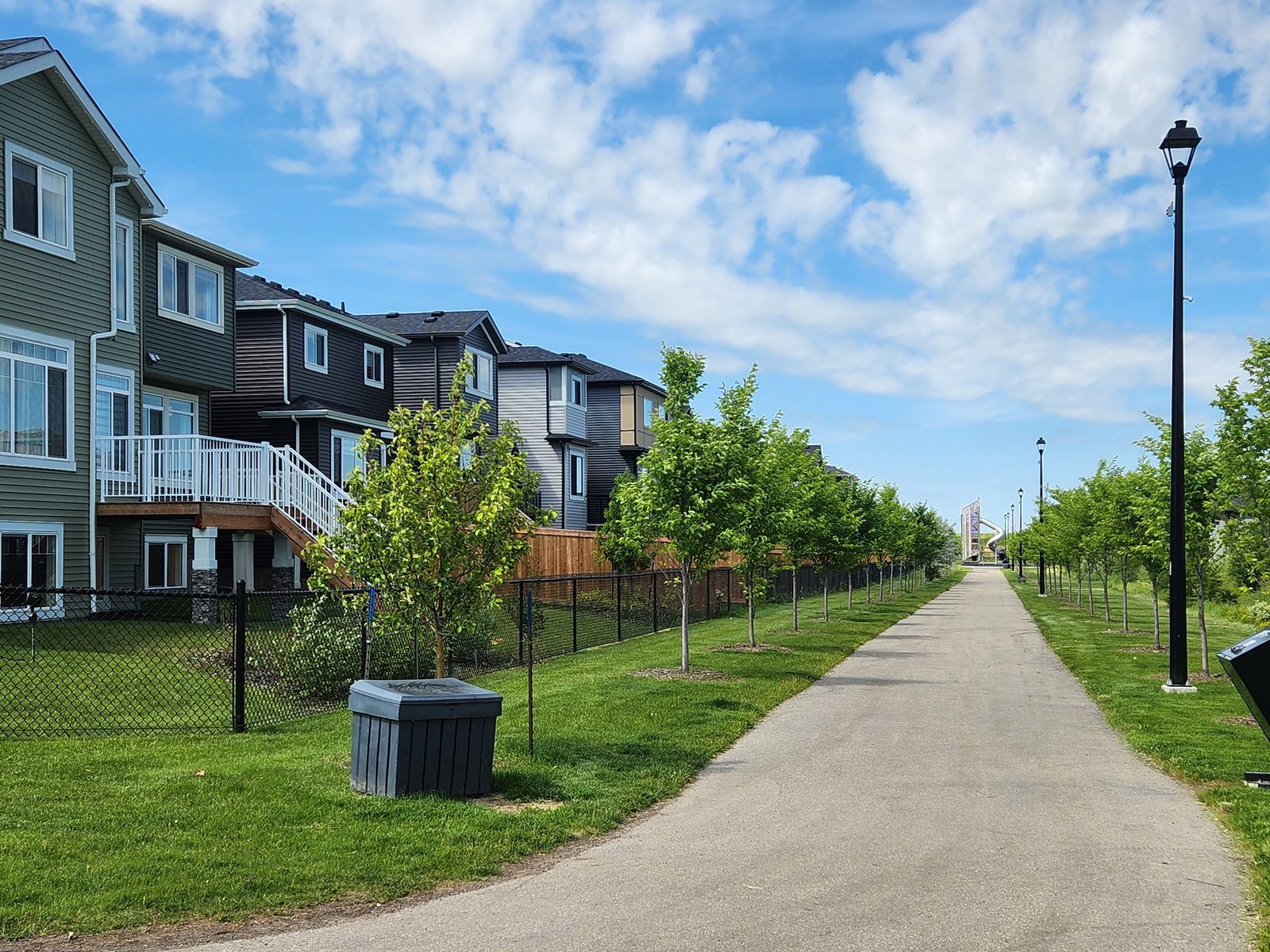 Tree-lined walking trail connecting homes and parks in Élan, Beaumont